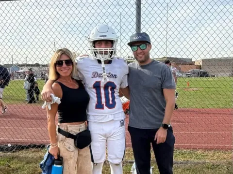Helen and family with a football player after a game