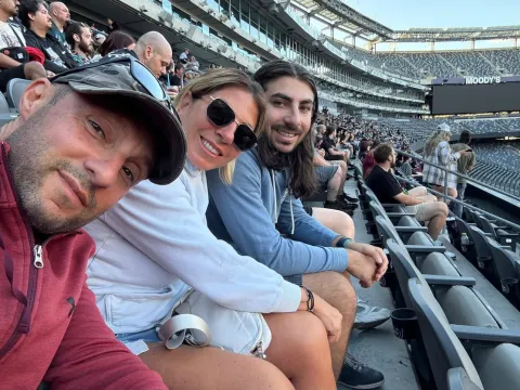 Helen and family in the stands at a stadium