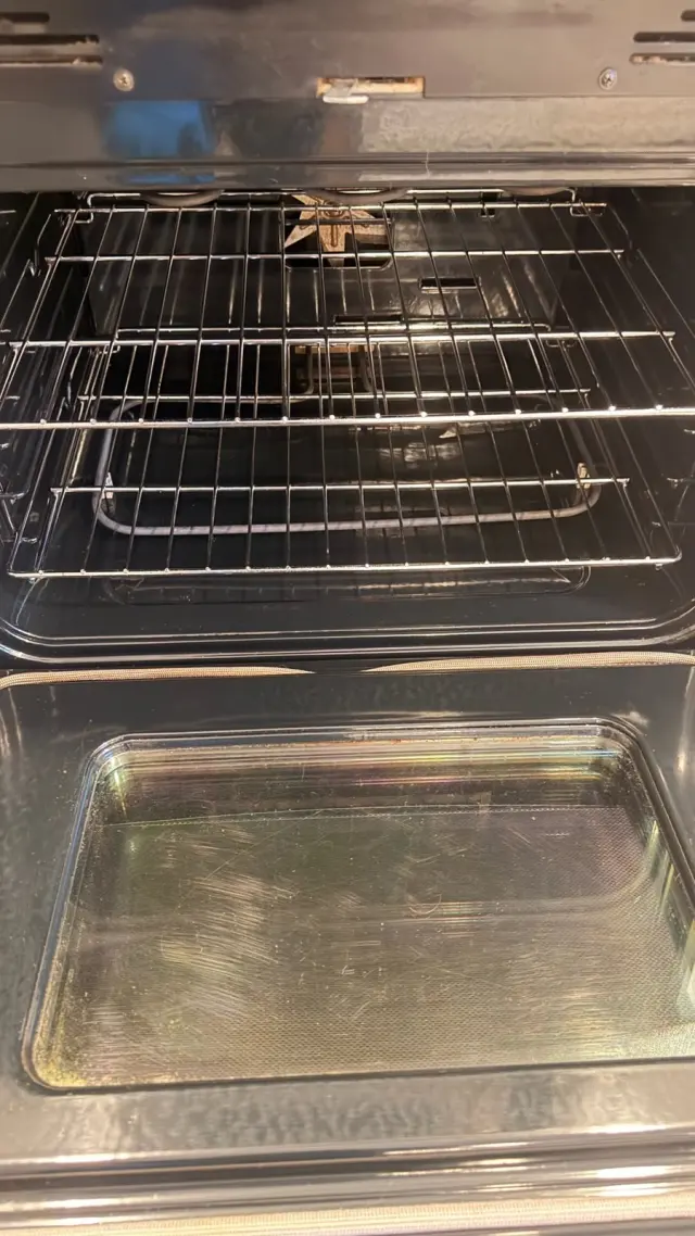 The same oven after a deep clean, with clean racks and a clear floor