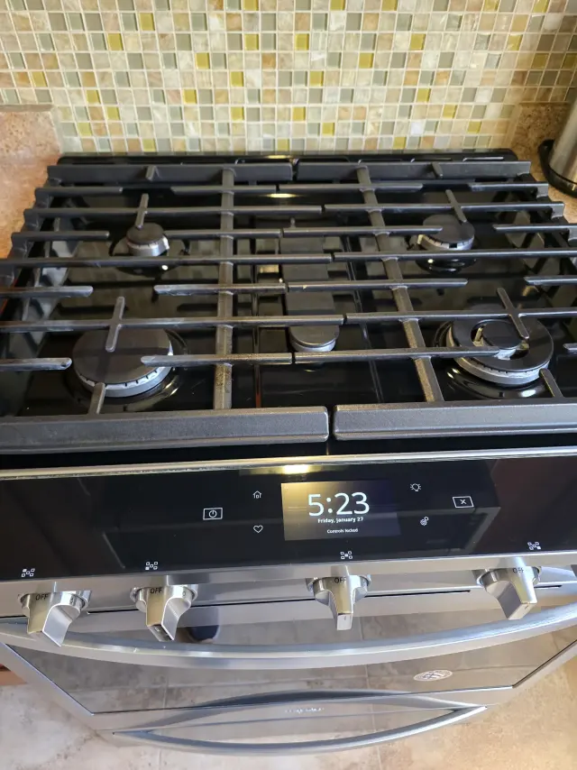 The same stovetop after cleaning, with detailed burners and grates